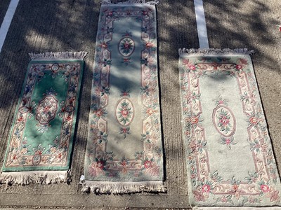 Lot 1301 - Three Chinese wash rugs with floral decoration on green ground, 220cm x 70cm, 160cm x 76cm and 128cm x 60cm