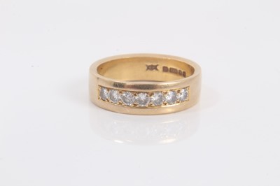 Lot 680 - 18ct yellow gold ring with a band of seven brilliant cut diamonds in channel setting