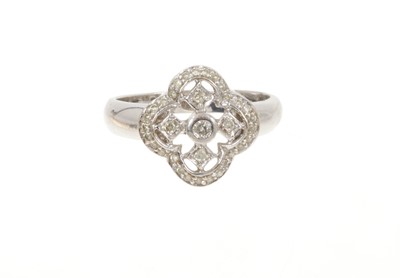 Lot 687 - Diamond quatrefoil cluster ring with open work design and pair of matching earrings in white gold setting