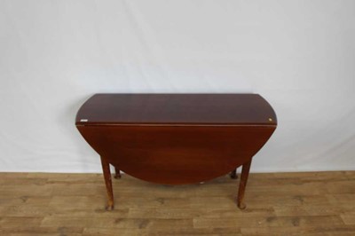 Lot 1353 - Mahogany oval drop leaf table on turned legs, opening to 128cm x 122cm