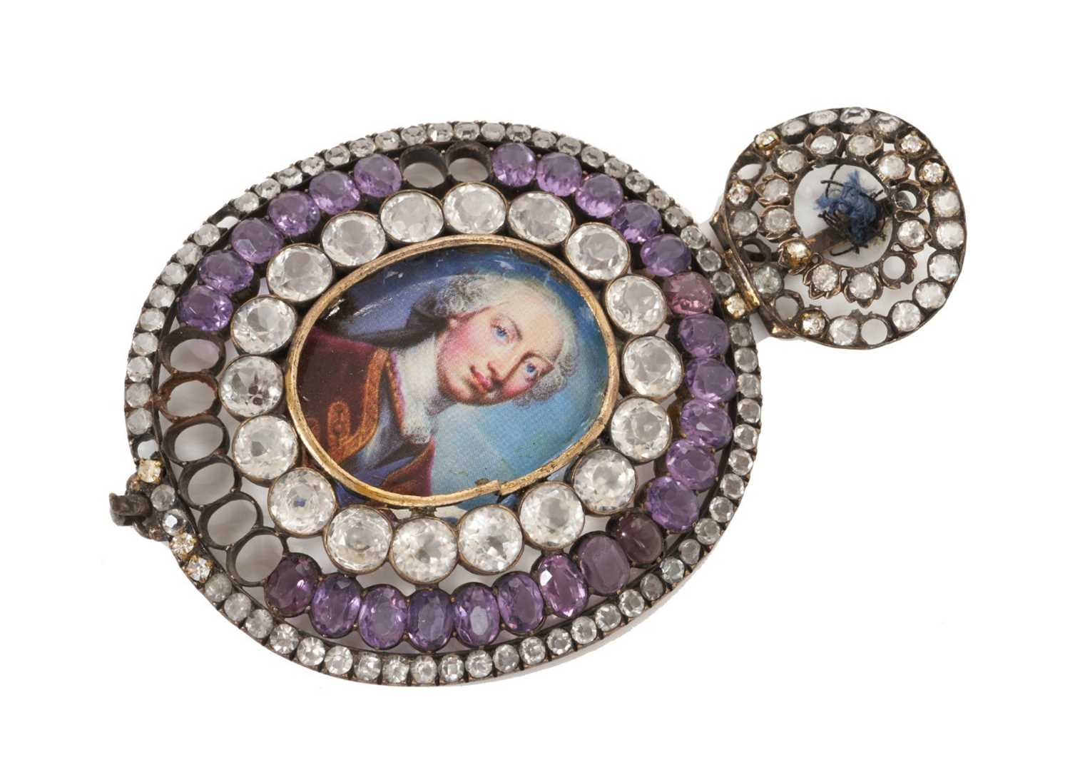 Lot 6 - Formerly the property of Sir Cecil Beaton CBE, 19th century paste set Royal Family Order sash badge of oval form set with purple and white stones with later printed portrait to centre 10.5 cm high...