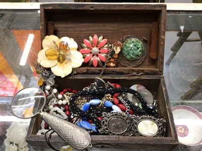 Lot 1115 - Small wooden box of costume jewellery and a magnifying glass