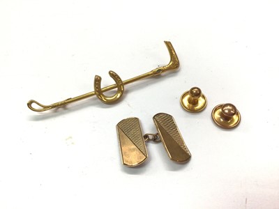 Lot 1056 - 9ct gold riding crop brooch, two 9ct gold studs and one 9ct gold cufflink