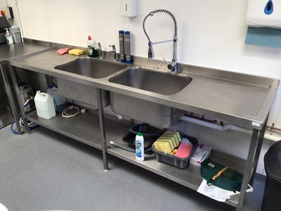 Lot 2 - A stainless steel double bowl sink unit with pre-rinse flexi-hose  tap and pair of taps, plus shelf under, 2400mm
