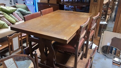 Lot 1391 - Old Charm style oak draw leaf dining table on pierced shaped end standards joined by stretcher, together with a set of eight oak dining chairs with studded seats