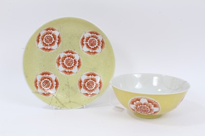 Lot 329 - A Chinese yellow ground sgraffito bowl and dish, decorated with roundels containing bats and shou characters in iron red enamel, marks to bases