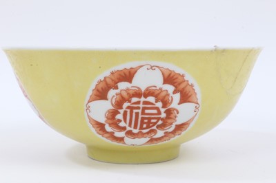 Lot 58 - A Chinese yellow ground sgraffito bowl and dish, decorated with roundels containing bats and shou characters in iron red enamel, marks to bases