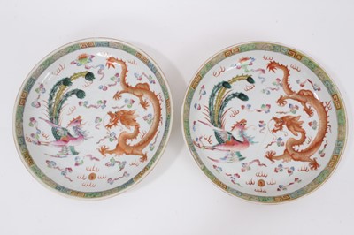 Lot 339 - A pair of Chinese polychrome painted porcelain dishes, decorated with a dragon and phoenix pattern