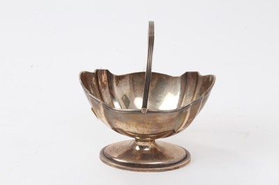 Lot 426 - Victorian silver swing handled sugar bowl of faceted boat shaped form, with reeded border, on an oval pedestal base (London 1885) Goldsmith's Alliances Ltd. All at approximately 4ozs. 12.3cm across...
