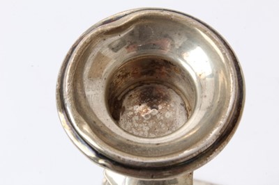 Lot 427 - Pair George V silver candlesticks with tapering octagonal stems and inverted bell candleholders, on octagonal pyramid bases, loaded (Birmingham 1918) Henry Williamson Ld. 26cm overall height.