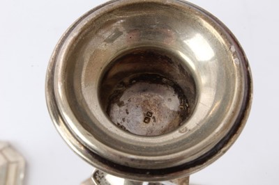 Lot 427 - Pair George V silver candlesticks with tapering octagonal stems and inverted bell candleholders, on octagonal pyramid bases, loaded (Birmingham 1918) Henry Williamson Ld. 26cm overall height.