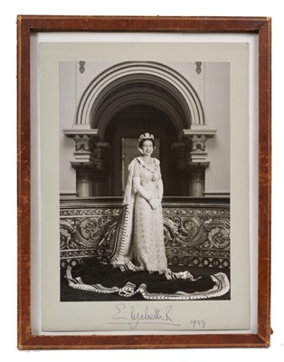 Lot 25 - Her Late Majesty Queen Elizabeth II, fine and unusual signed presentation portrait photograph of Her Majesty wearing state robes and smiling signed in ink on mount 'Elizabeth R 1959' in glazed leat...