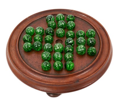 Lot 918 - Carved walnut solitaire board housing unusual collection of 32 antique green glass marbles