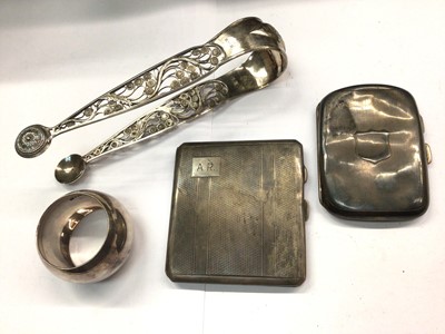 Lot 1086 - Two silver cigarette cases, pair white metal filigree sugar tongs and plated napkin ring