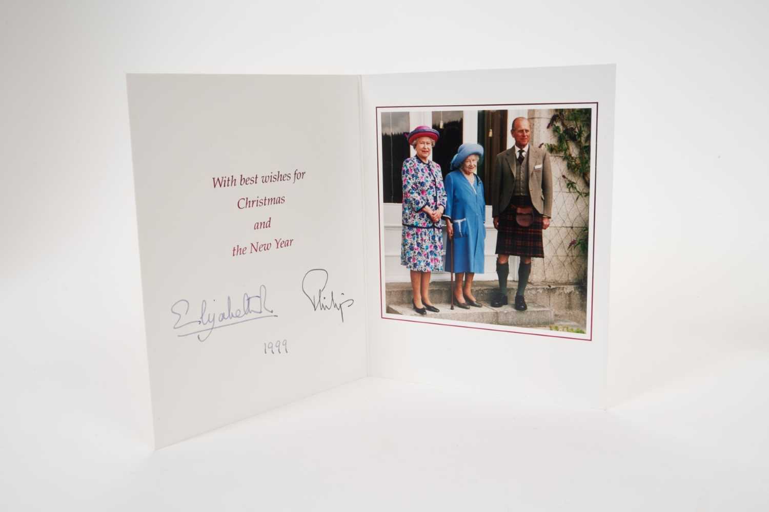 Lot 29 - H.M.Queen Elizabeth II and H.R.H.The Duke of Edinburgh signed 1999 Christmas card with twin gilt ciphers to cover, colour photograph of the Royal couple with The Queen Mother at Balmoral, signed 'E...