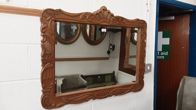 Lot 1426 - Bevelled wall mirror in carved wooden frame