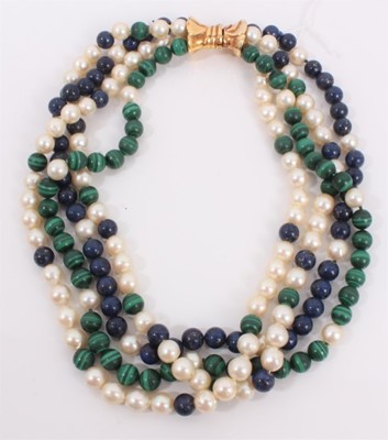 Lot 210 - Cultured pearl, malachite and lapis lazuli bead four strand necklace with 14ct gold bow shaped clasp