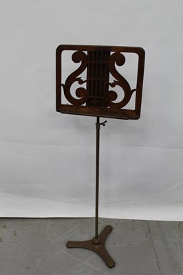 Lot 1469 - 19th century walnut music stand with pierced lyre design on adjustable stand