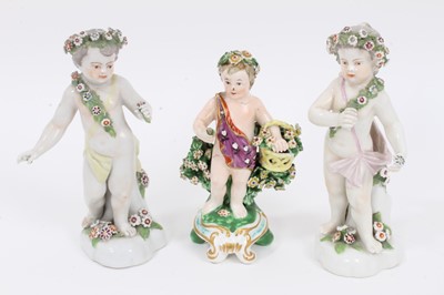 Lot 258 - Derby figure of a putto with a basket, circa 1810, and two Derby style figures of putto