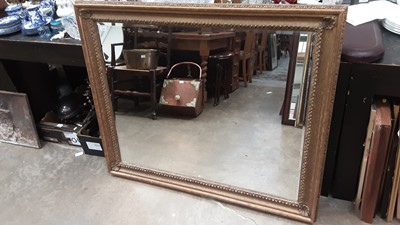 Lot 1434 - Bevelled wall mirror in ornate gilt frame, 121cm x 98cm