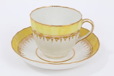 Lot 278 - A Derby faceted tea cup and saucer, with yellow ad gilt borders, circa 1790