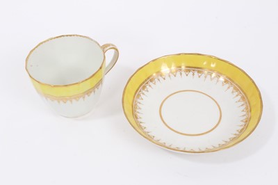 Lot 123 - A Derby faceted tea cup and saucer, with yellow ad gilt borders, circa 1790
