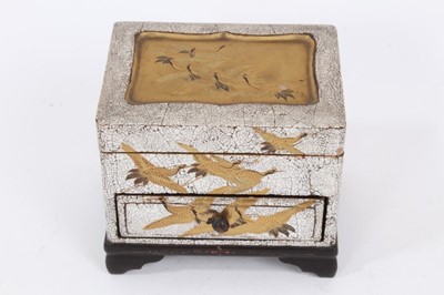 Lot 916 - A miniature Japanese lacquered box with lift-out boxes and drawer, decorated in gilt with cranes, 9.5cm wide