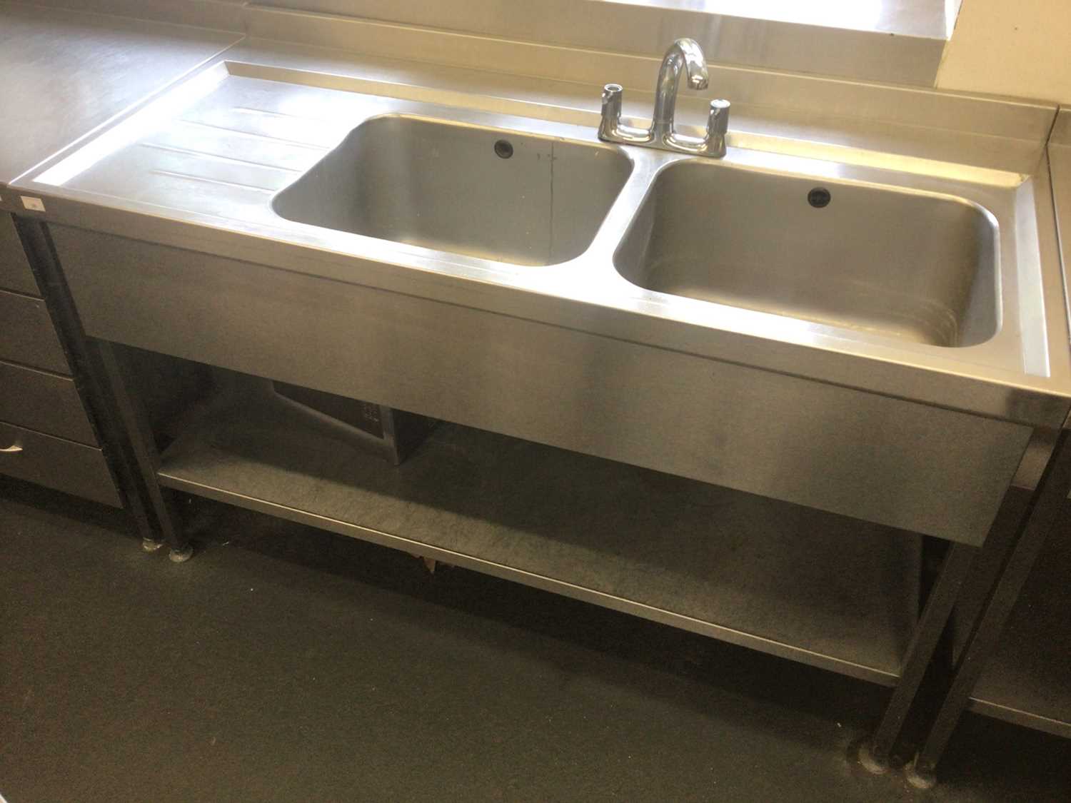 Lot 28 - A stainless steel double bowl sink unit, with mixer tap and undershelf, 1500 mm