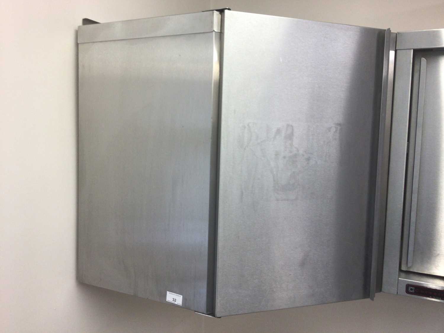 Lot 32 - A stainless steel corner wall cabinet, with single door, 660 mm wide x 660 mm deep