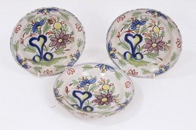 Lot 243 - Three small 18th century Delft polychrome dishes, decorated with flowers, 16.5cm diameter