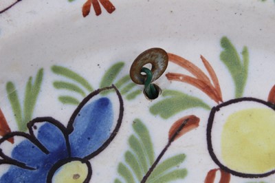 Lot 243 - Three small 18th century Delft polychrome dishes, decorated with flowers, 16.5cm diameter