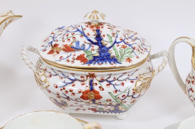 Lot 244 - An early 19th century Crown Derby tea set, decorated in the Imari style, including teapot and stand, sucrier, bowl, seven saucers, eight coffee cans, and eight tea cups
