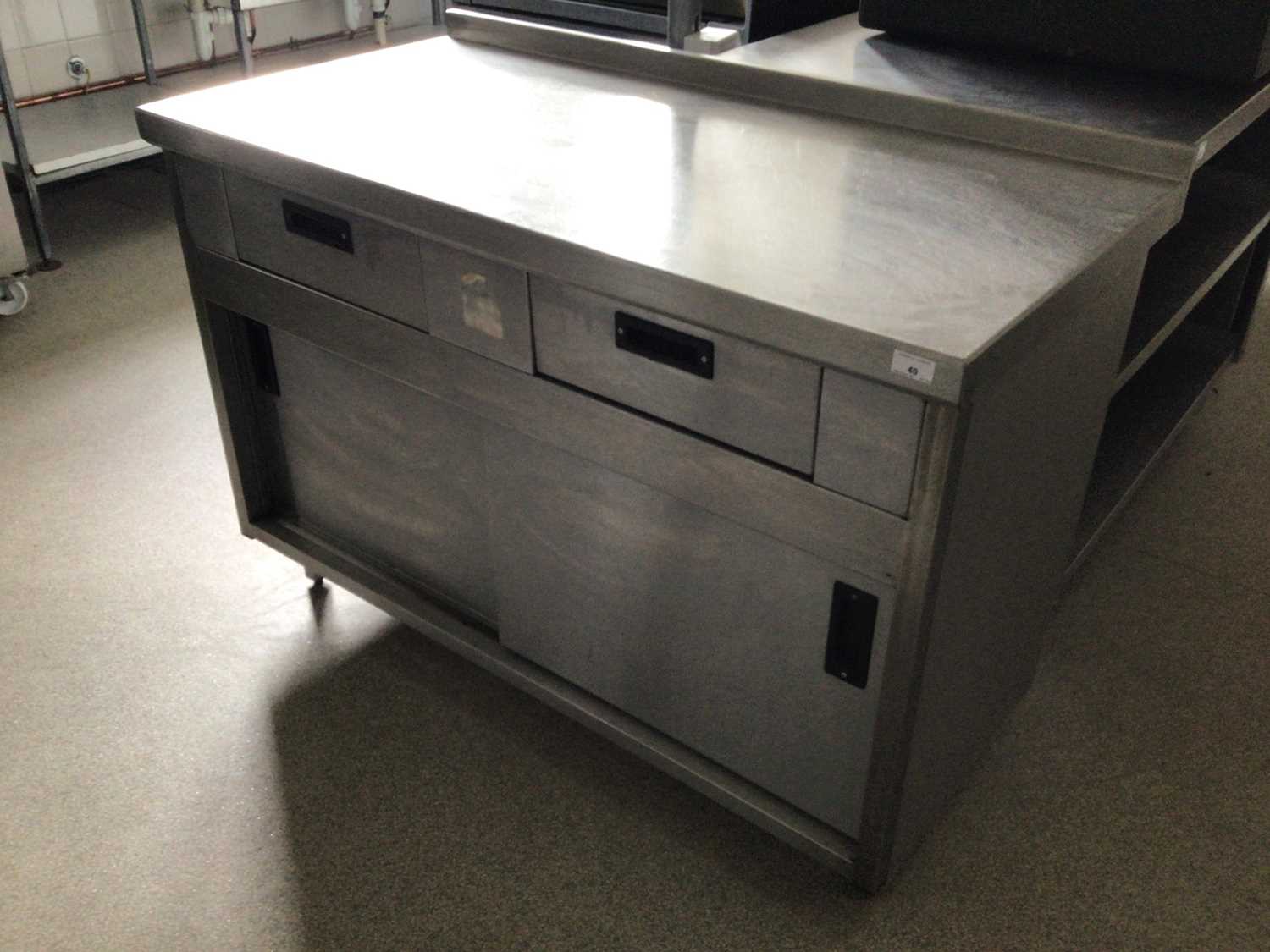 Lot 40 - A wall standing stainless steel preparation bench, with two drawers, and double sliding doors, 1200 mm