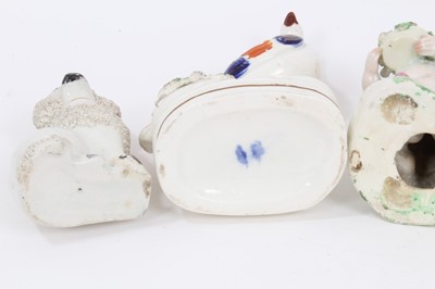 Lot 248 - A Derby figure of a cherub, circa 1800, together with a pair of Staffordshire exotic bird pen holders, and a pair of Staffordshire spaniels (5)