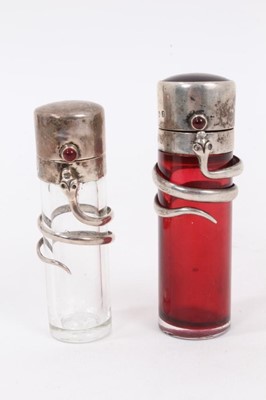 Lot 913 - A late Victorian novelty silver snake scent bottle, cylindrical form with cabochon garnet thumbpiece and guilloche enamel terminal, Birmingham 1898, 7.5cm high, together with another smaller.  (2)