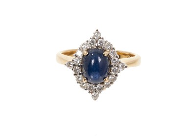 Lot 767 - Cabochon sapphire and diamond cluster ring