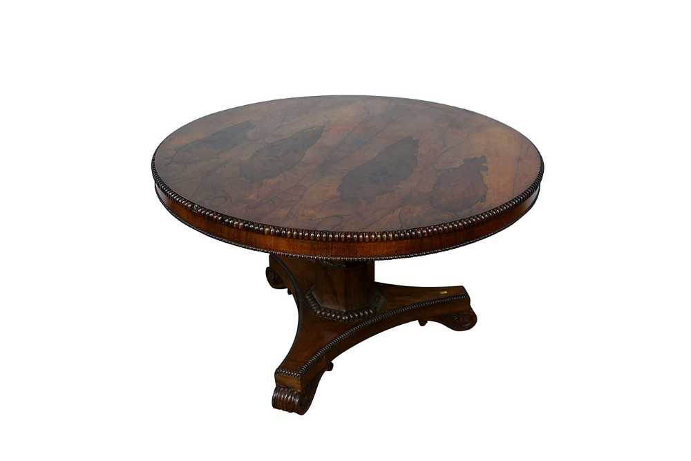 Lot 1401 - William IV rosewood circular breakfast table, the tilt top with beaded edge on facetted column and shaped triangular platform on scroll feet, 123cm diameter