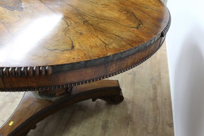 Lot 1401 - William IV rosewood circular breakfast table, the tilt top with beaded edge on facetted column and shaped triangular platform on scroll feet, 123cm diameter