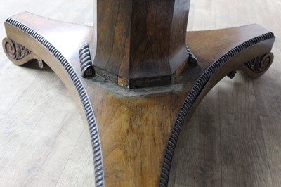 Lot 1401 - William IV rosewood circular breakfast table, the tilt top with beaded edge on facetted column and shaped triangular platform on scroll feet, 123cm diameter