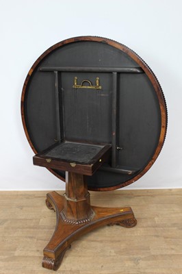 Lot 1401 - William IV rosewood circular breakfast table, the tilt top with beaded edge on facetted column and shaped triangular platform on scroll feet, 123cm diameter