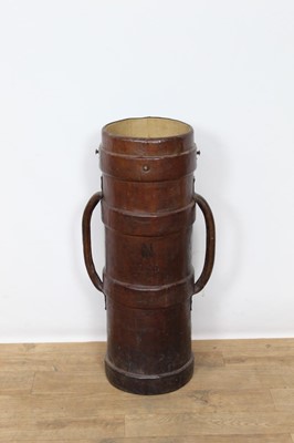 Lot 1405 - Antique brown leather artillery shell carrier, with flanking handles, 75cm high