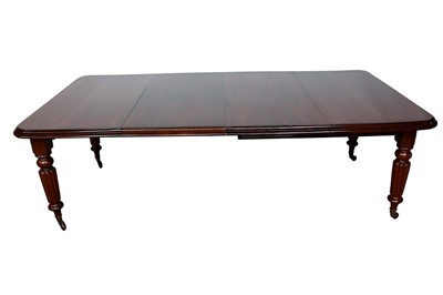 Lot 1409 - Victorian mahogany extending dining table, the rounded rectangular wind out top on turned fluted legs and castors, with two additional leaves, 120 x 234cm when extended