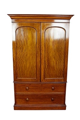 Lot 1415 - Victorian flame mahogany twin wardrobe, with moulded cornice and enclosed by a pair of arch panel doors, on two long drawers and plinth base, 121cm wide x 52cm deep x 215cm high