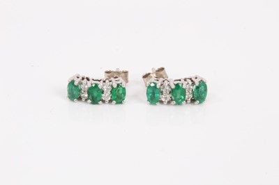 Lot 795 - Pair of diamond and green stone earrings in 14ct white gold setting.