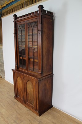 Lot 1424 - 19th century Gothic mahogany two height bookcase, with crenellated cornice and open adjustable shelves flanked by projecting columns, the base with two arched panel doors on plinth base, 110cm wide...