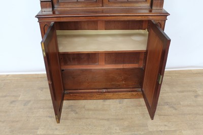 Lot 1424 - 19th century Gothic mahogany two height bookcase, with crenellated cornice and open adjustable shelves flanked by projecting columns, the base with two arched panel doors on plinth base, 110cm wide...