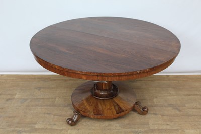 Lot 1433 - Regency rosewood circular breakfast table, the circular tilt-top raised on tapered facetted column and circular base on scroll feet and castors, 124cm diameter