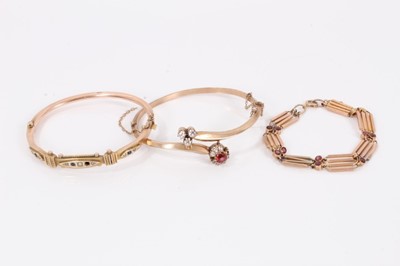 Lot 606 - Two late Victorian 9ct gold and gem set hinged bangles and 9ct rose gold gate style bracelet