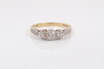 Lot 611 - Diamond three stone ring in platinum claw setting on 18ct yellow gold shank