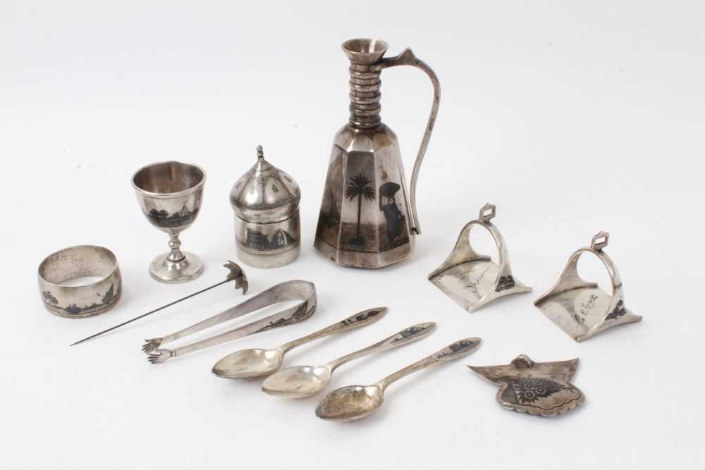Lot 484 - Collection of Iraqi white metal and niello wares to include ewer, teaspoons, sugar tongs and other items (11)